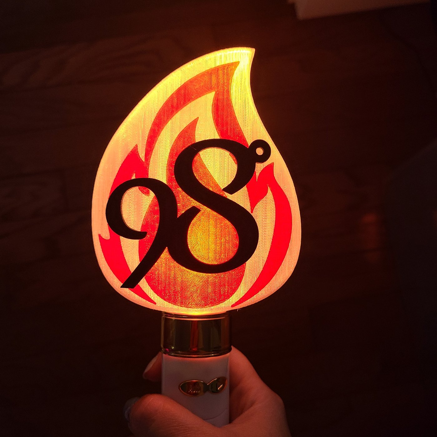 Custom translucent illuminated accessory interfacing with a commercial lightstick base